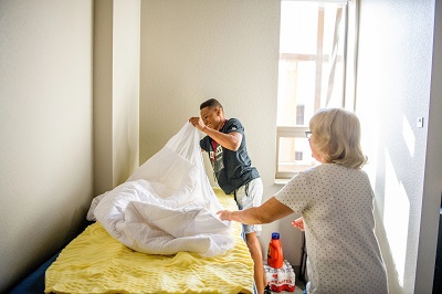 A student and parent making a bed in an ASU residence hall