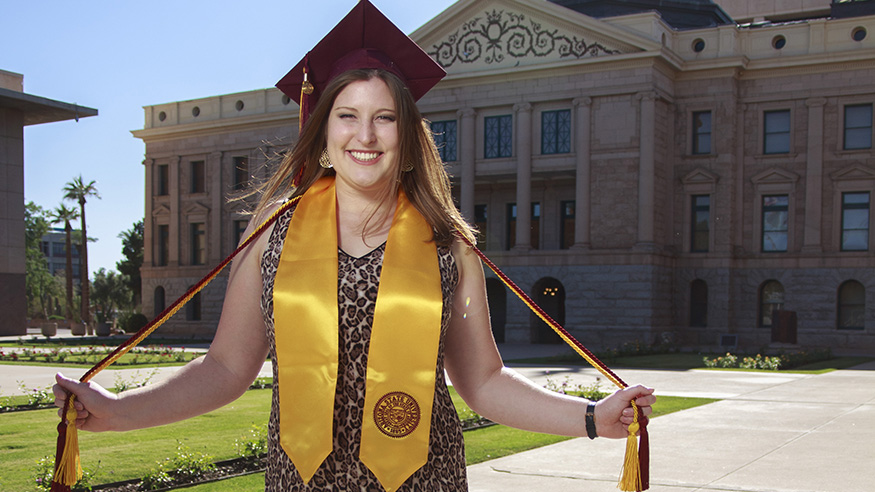  spring 2019 ASU graduate in front of the Arizona state capitol building