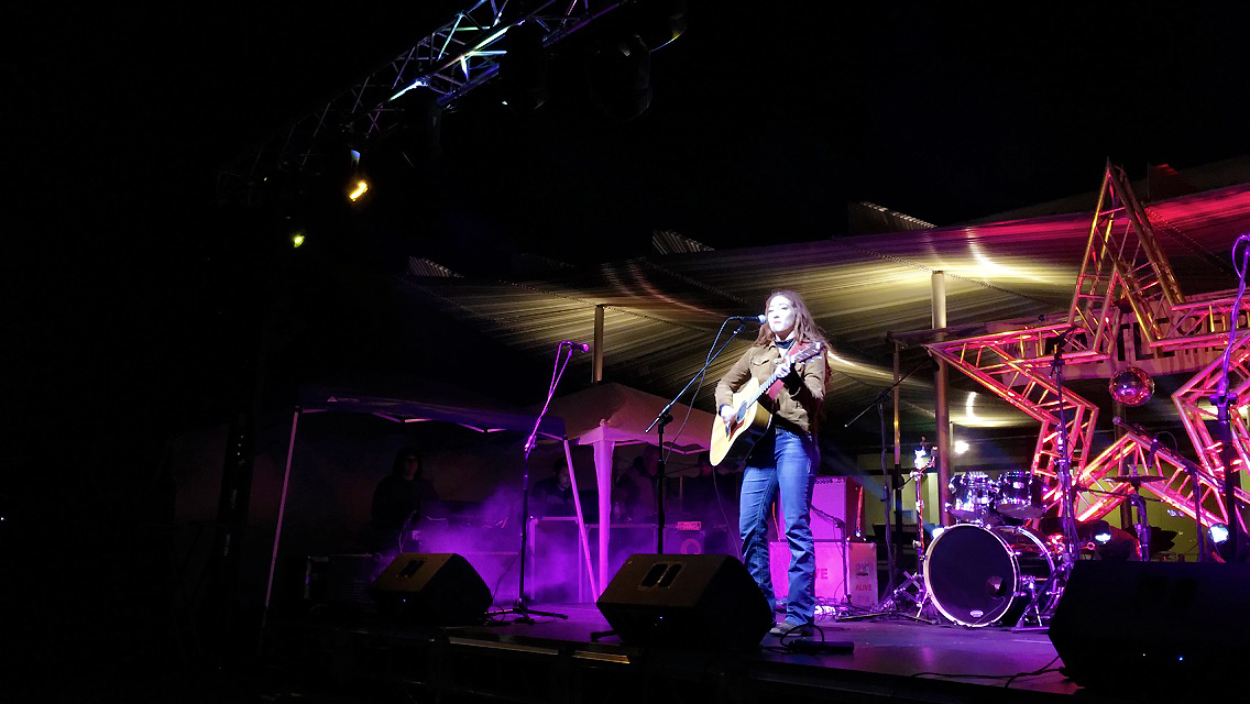 ASU engineering student Brittany Tews onstage with a guitar