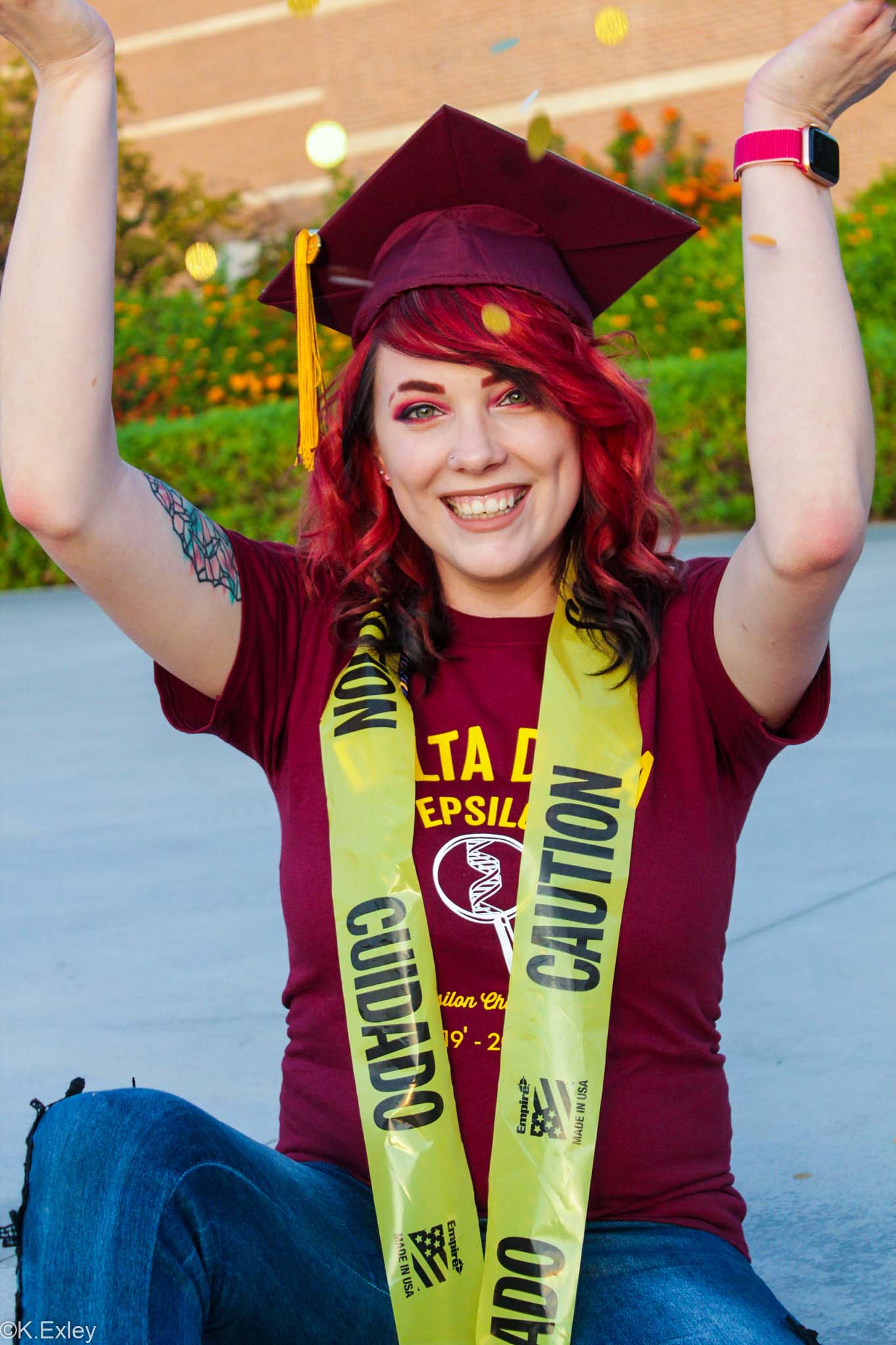 ASU grad Chelsie Marshall in her graduation cap with a caution tape sash