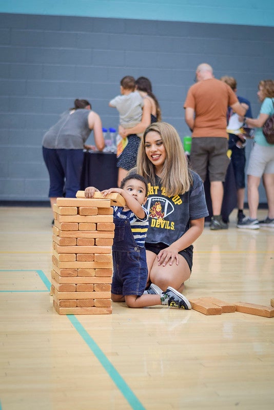 ASU student plays Jenga with her toddler sun