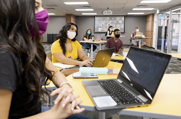 Students in masks in a classroom for an ASU Sync class