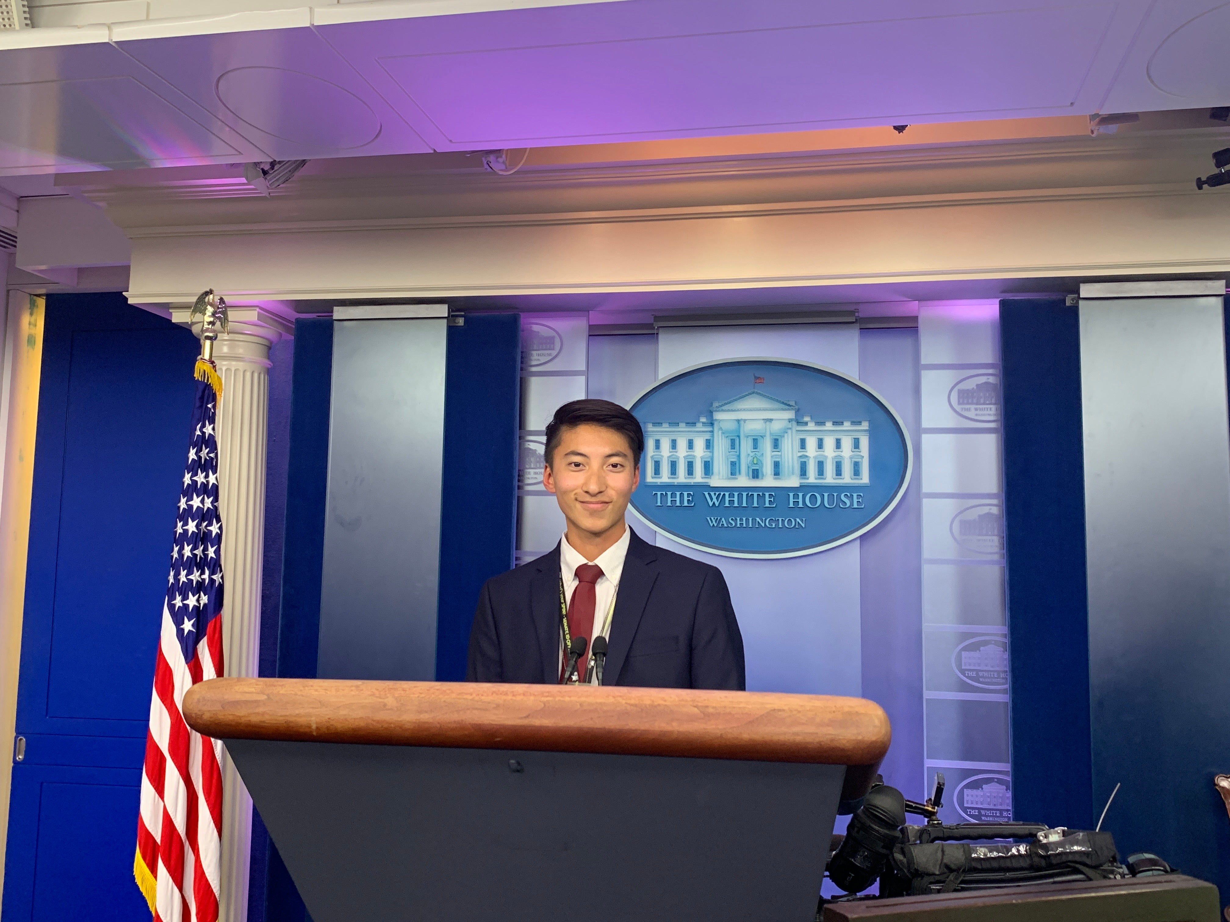 ASU Student Life Storyteller, Bryan Pietsch, poses at a podium in The White House