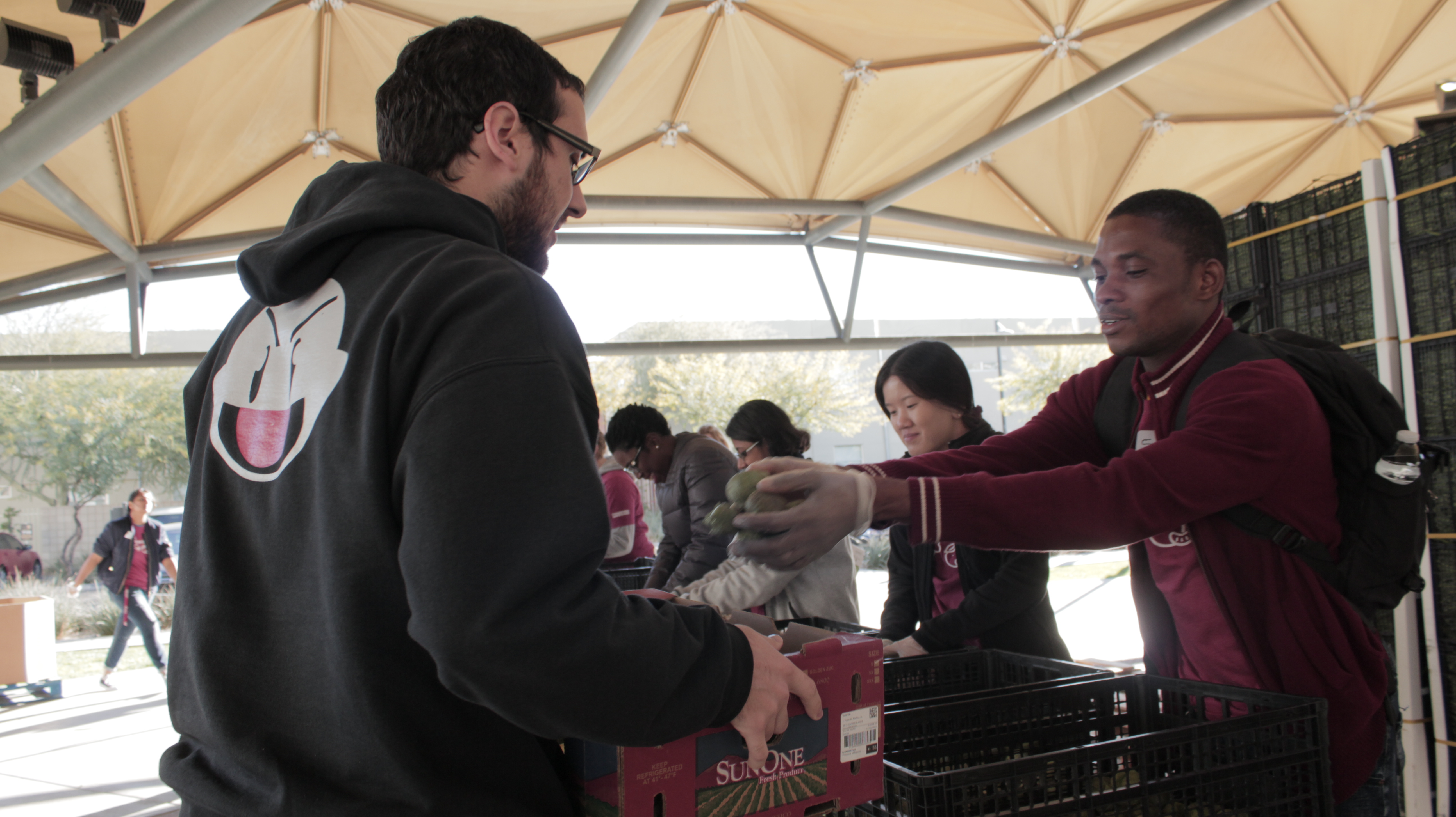 ASU students at the Vista del Sol golden dome hand out food with Borderlands Produce Rescue