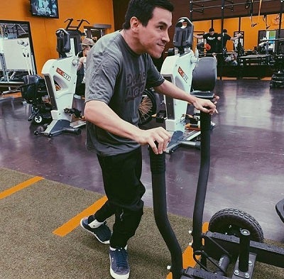 Adaptive athlete Victor Ocando pushes weights at the Sun Devil Fitness Complex