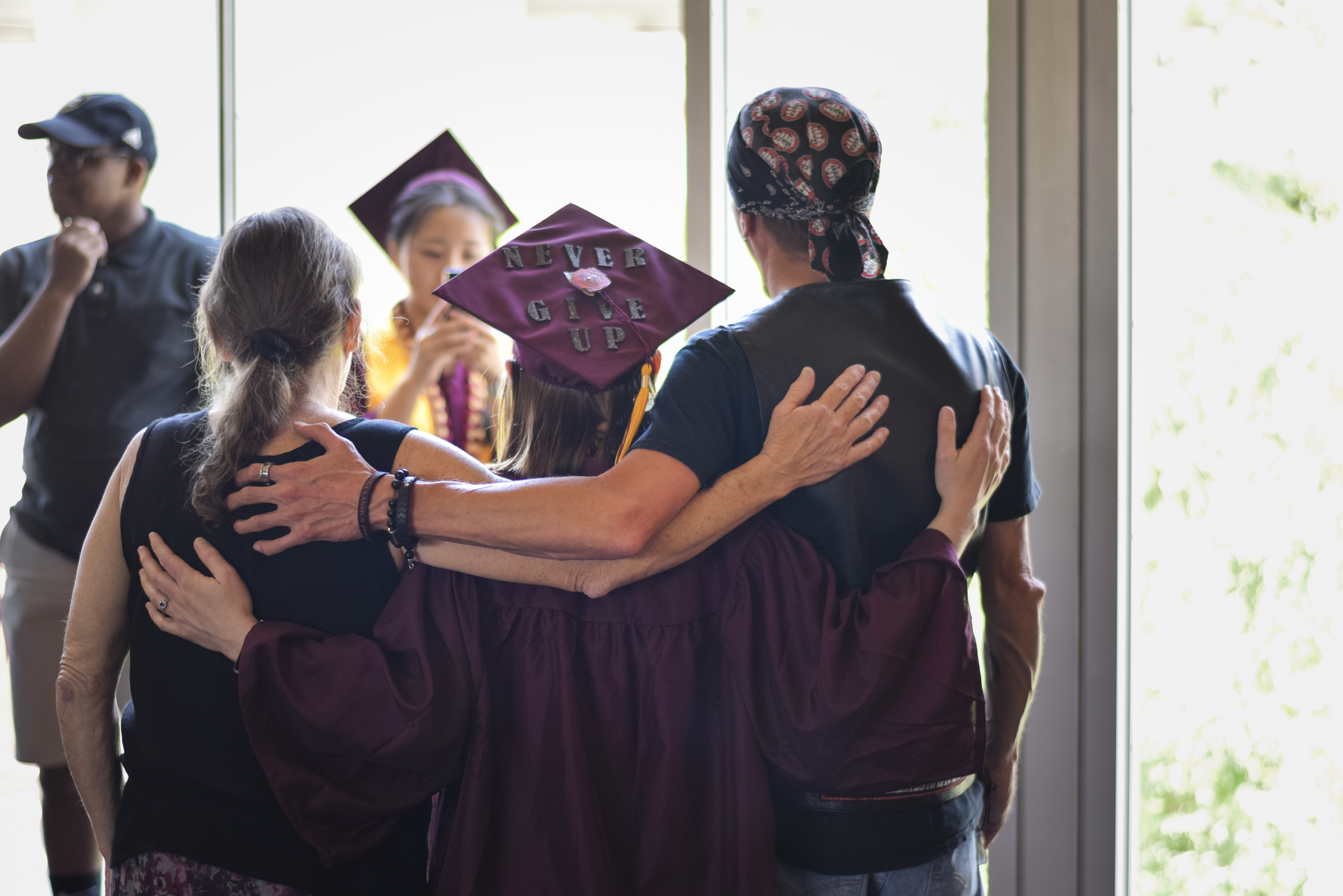 A graduate poses at the ASU Resiliency graduation spring 2019