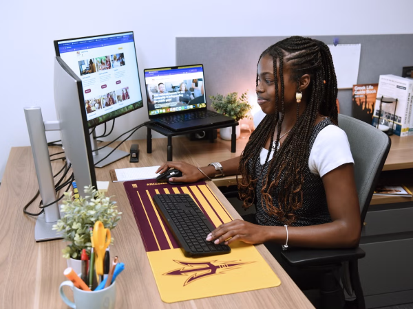 Student on Computer in Office Side Angle