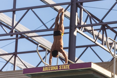 ASU diver Youssef Selim beginning a dive in a handstand